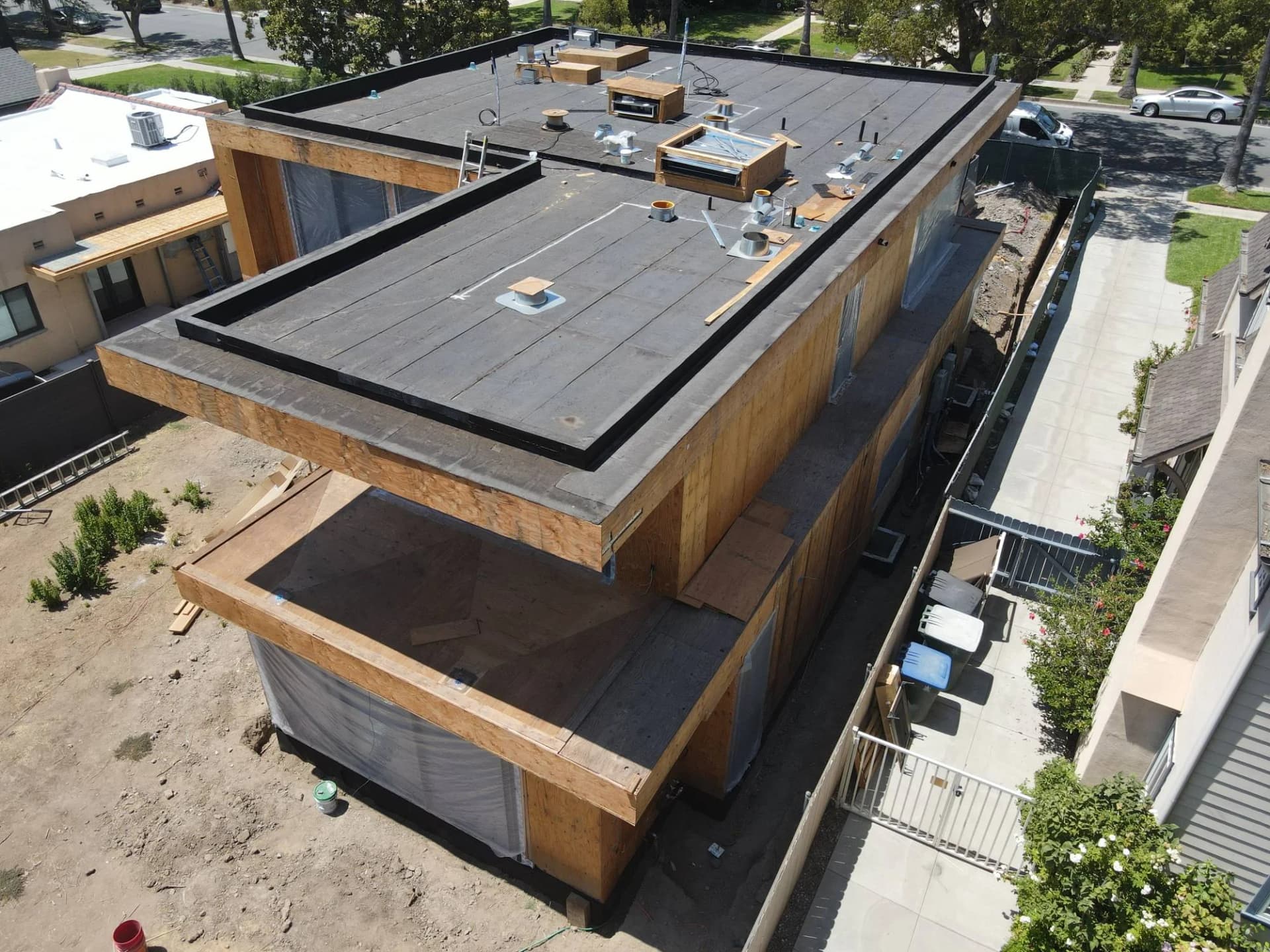 Aerial view of a flat roof with roofing work in progress