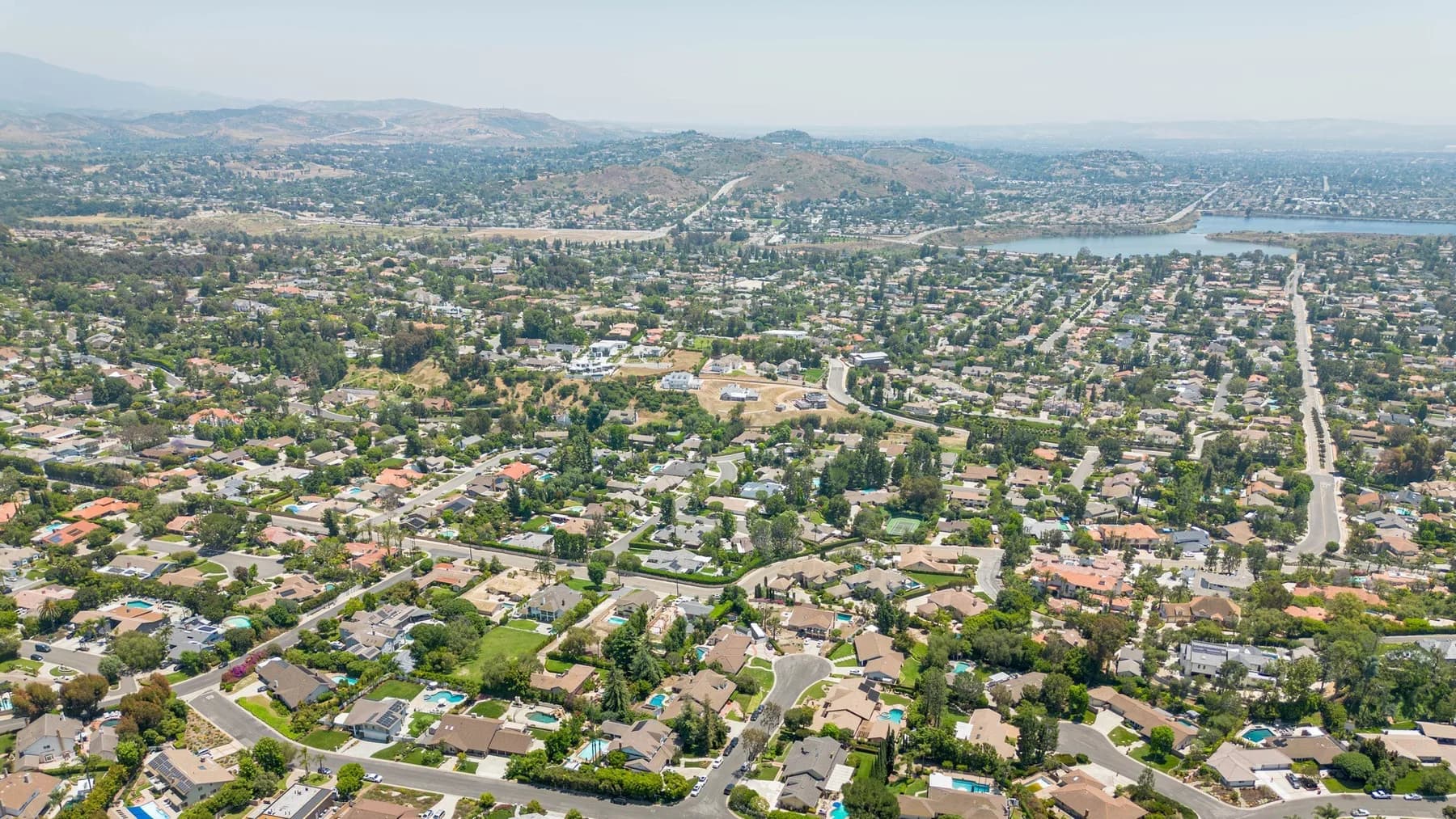 Aerial view of Orange County suburban neighborhoods with hills in the background