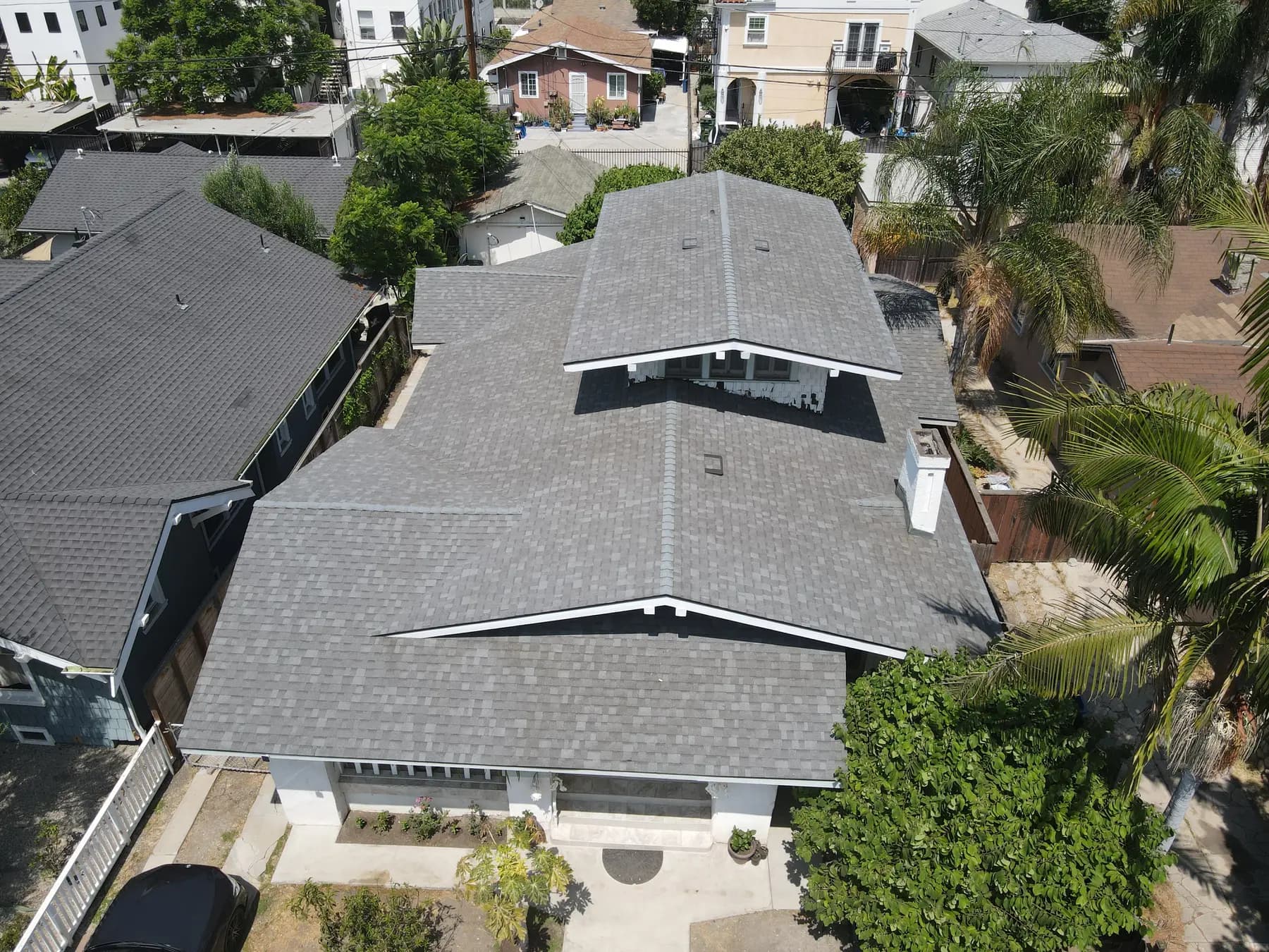 The front of the home from above, with its new gray shingles and gable edges framed by white trim