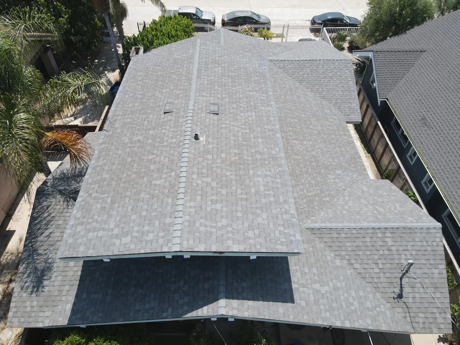Overhead view of the whole roof, showing its hips, ridges and valleys in one even gray finish