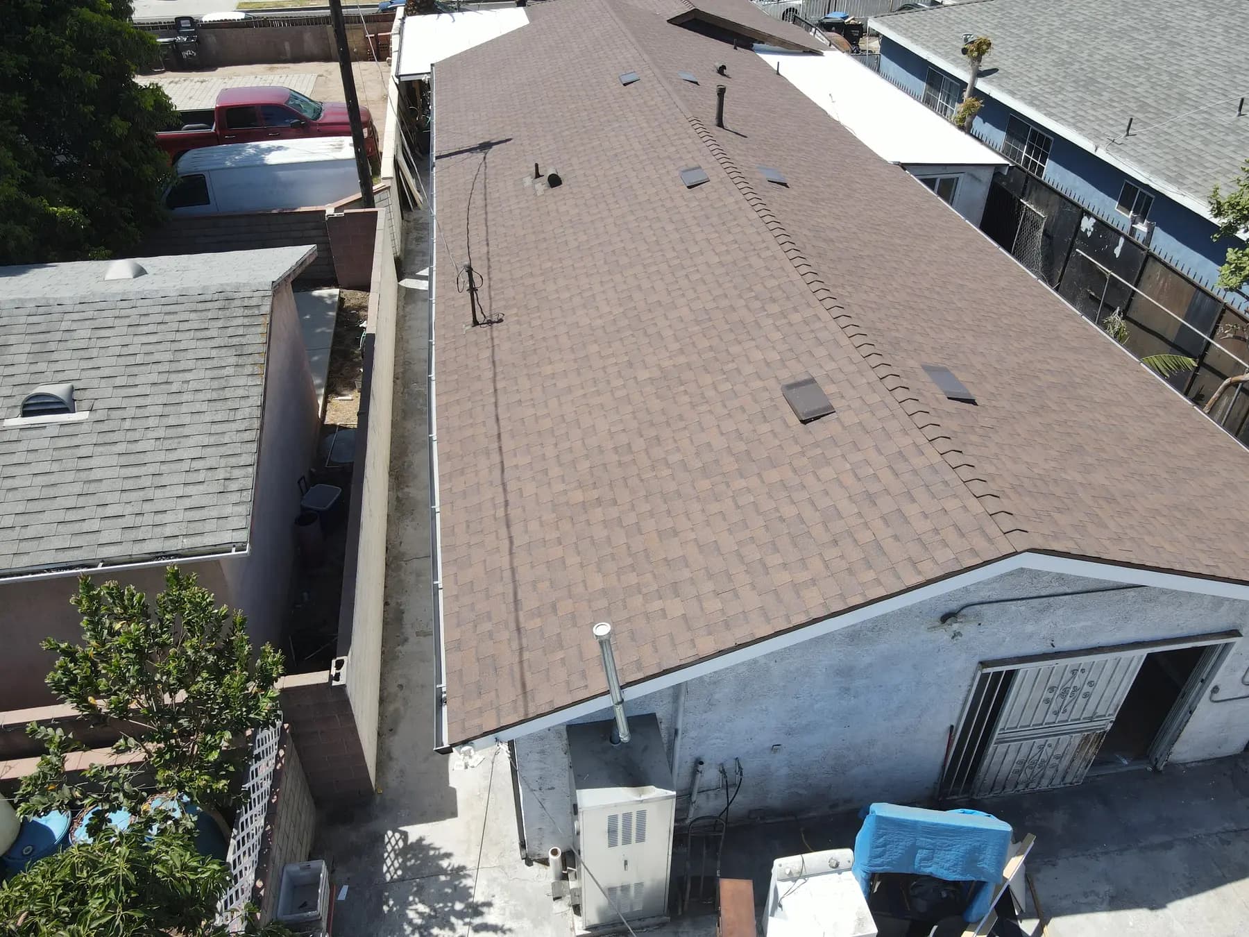 Another view of the rear building, with the new shingle roof, its box vents and its clean edges