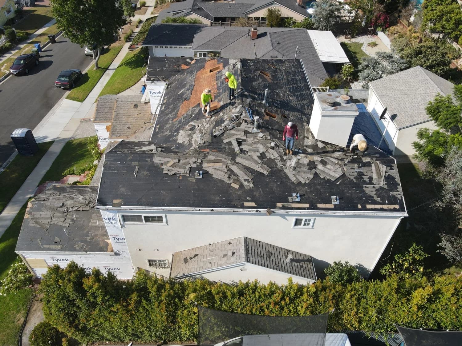 Aerial view of a shingle roof replacement in progress