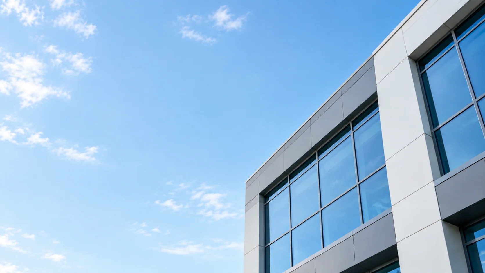 Modern office building exterior beneath a clear Southern California sky