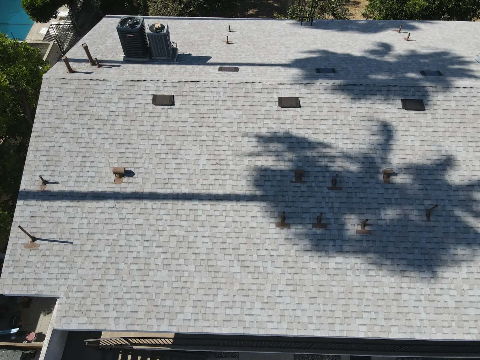 New box vents and pipe jacks flashed into a light gray shingle roof
