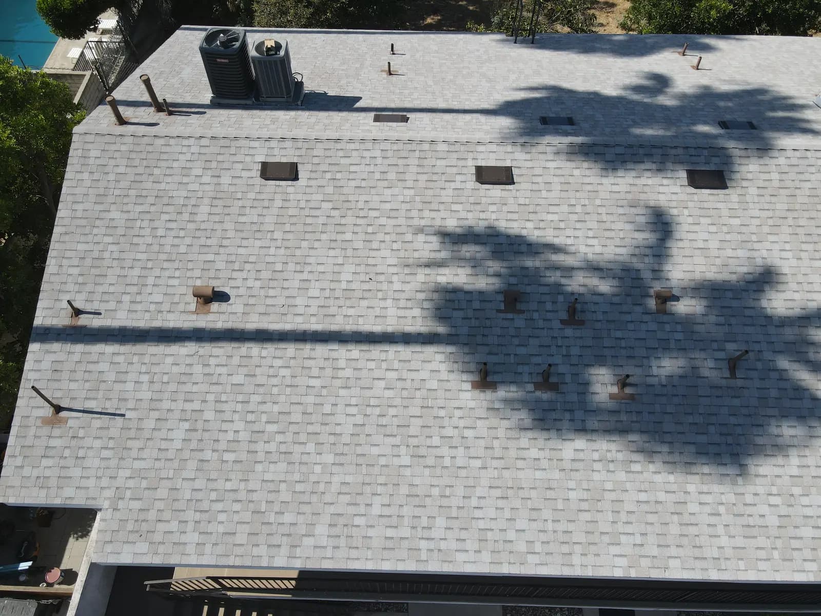 New box vents and pipe jacks flashed into a light gray shingle roof