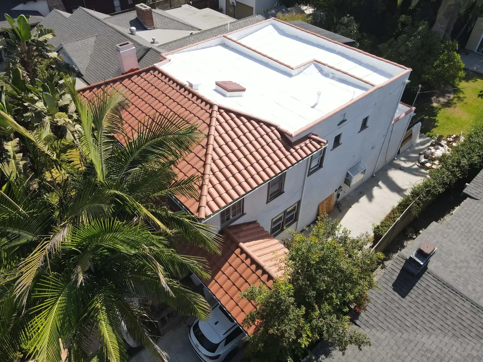 Spanish-style multi-family building in Mid-Wilshire with clay tile and a rooftop flat roof deck