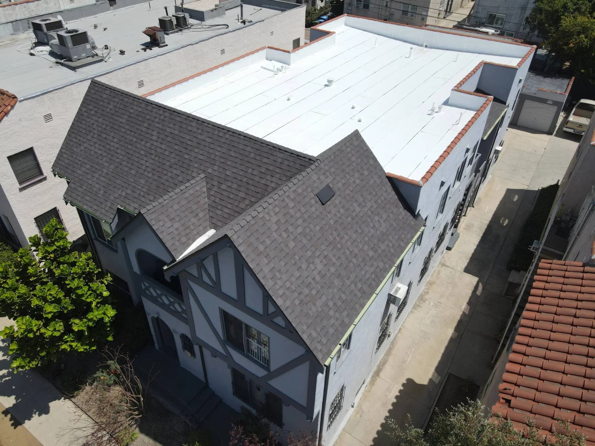 Multifamily building with tile and flat roof sections