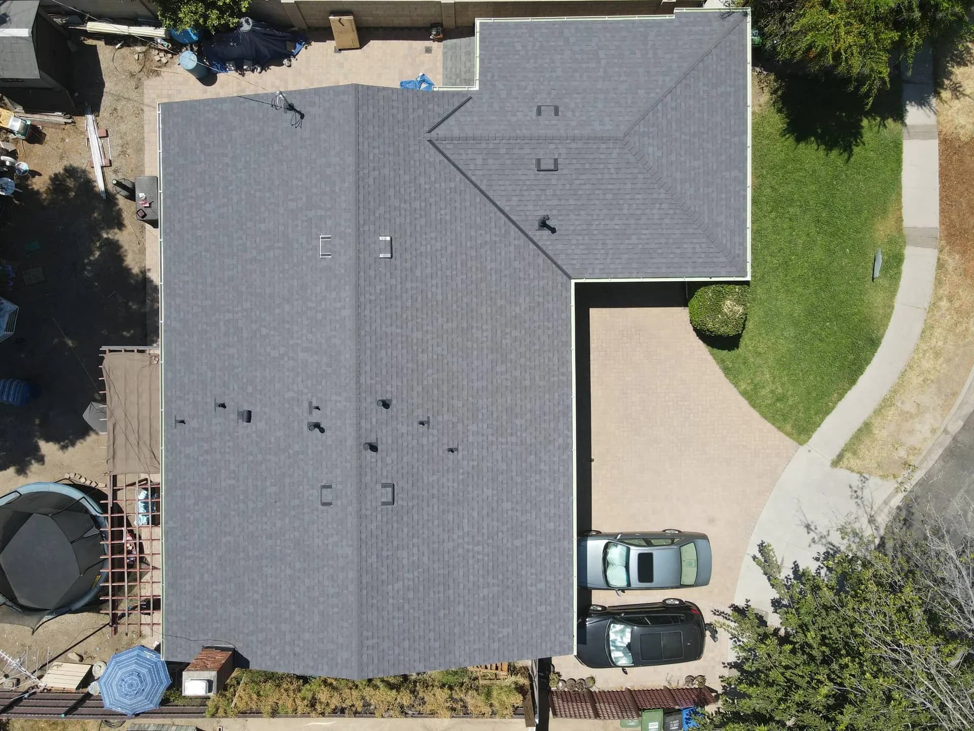 Aerial overhead view of a finished dark grey shingle roof